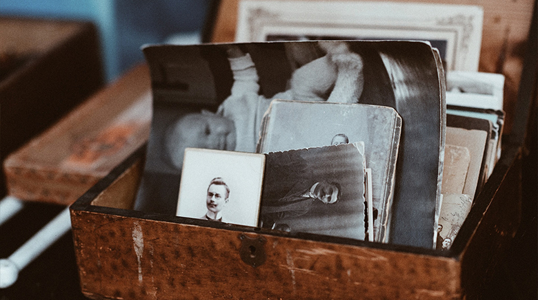 memory box full of black and white photos of a man and his loved ones