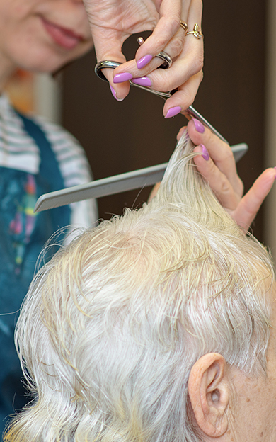 elderly lady having her hair cut in a salon