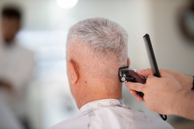 older man getting a haircut
