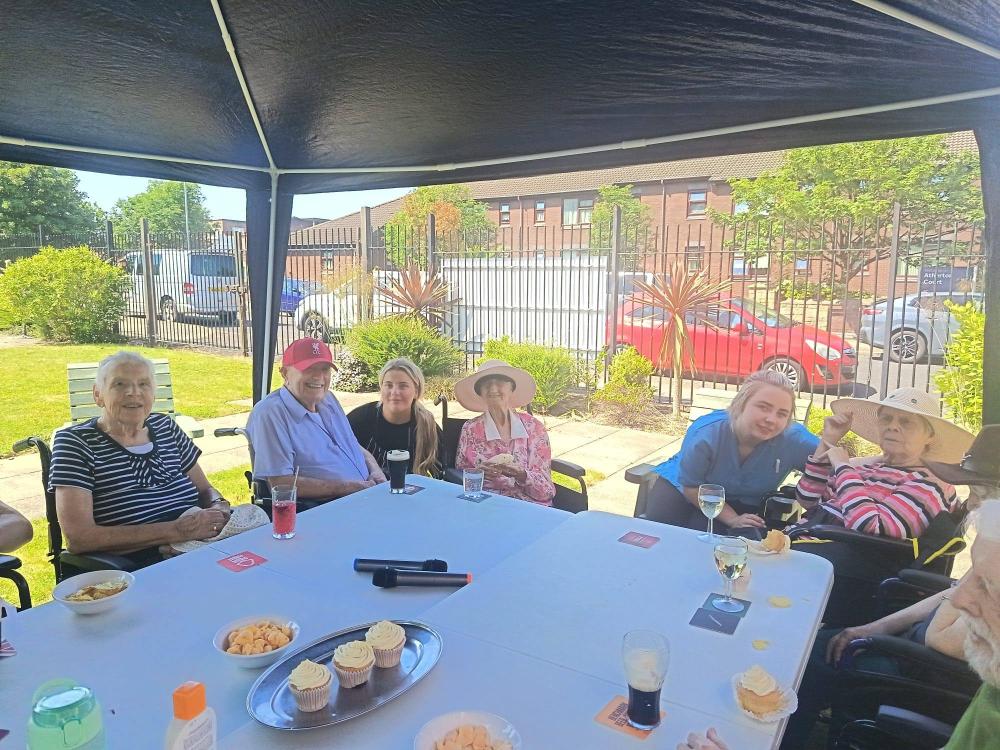 residents and carers sat in the garden