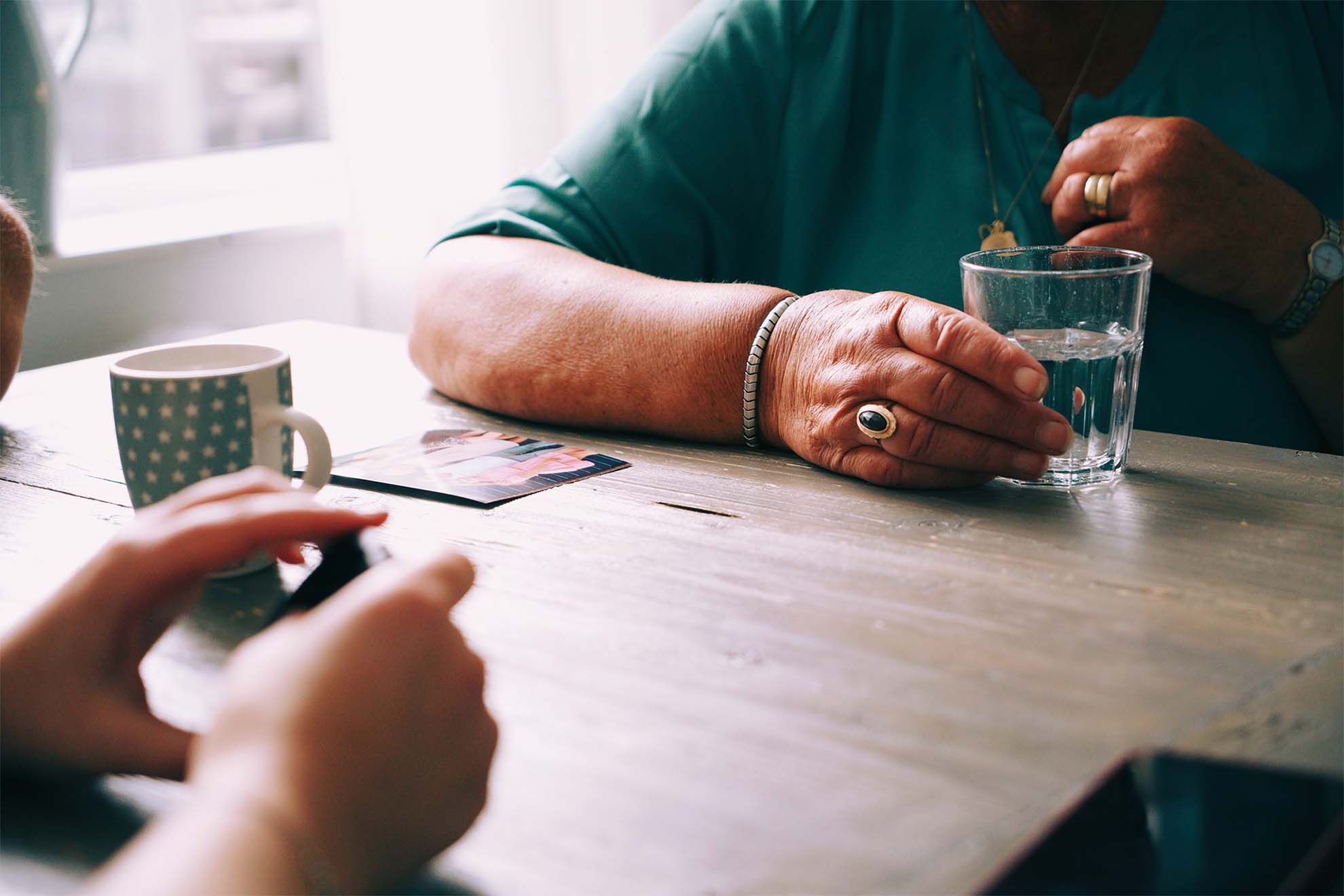 resident and carer playing cards