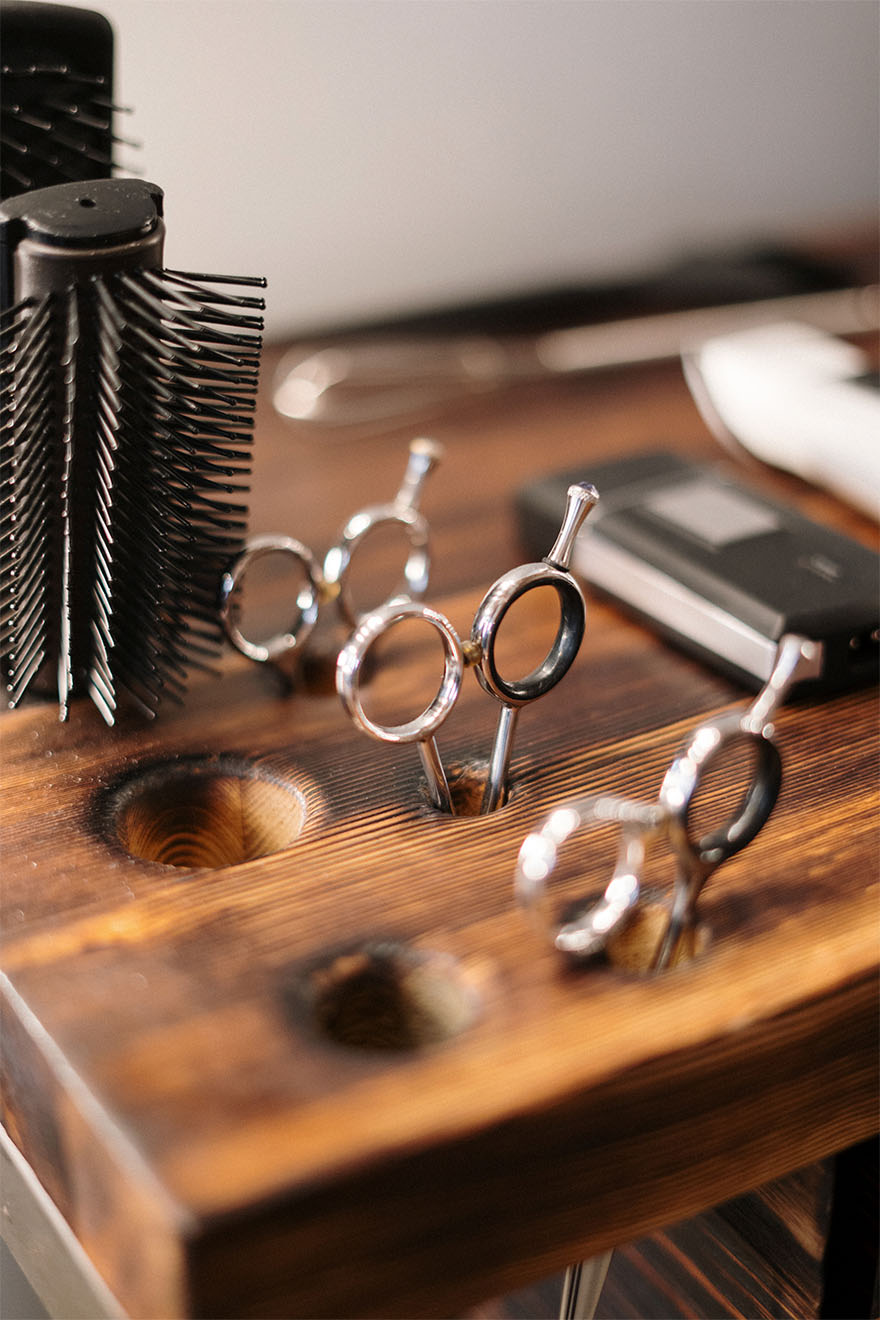 Hairdressing tools in a wooden holder