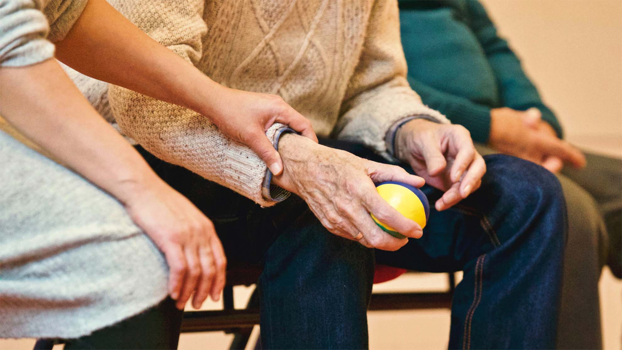 resident and carer playing with ball