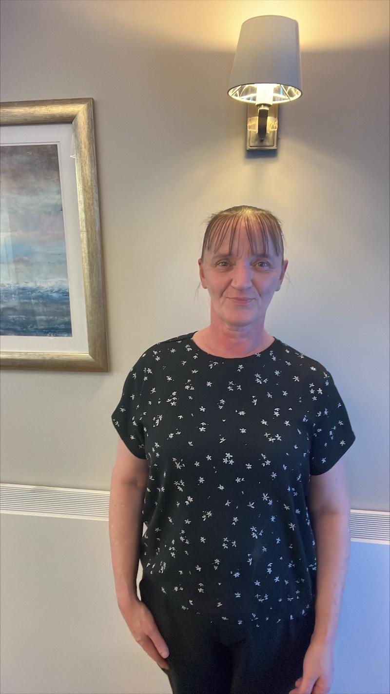 home manager sue stood having her photo taken for the website