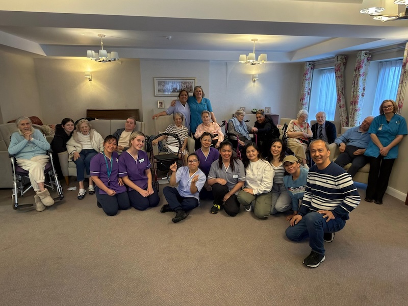a group photo of residents and team members in one of our lounges