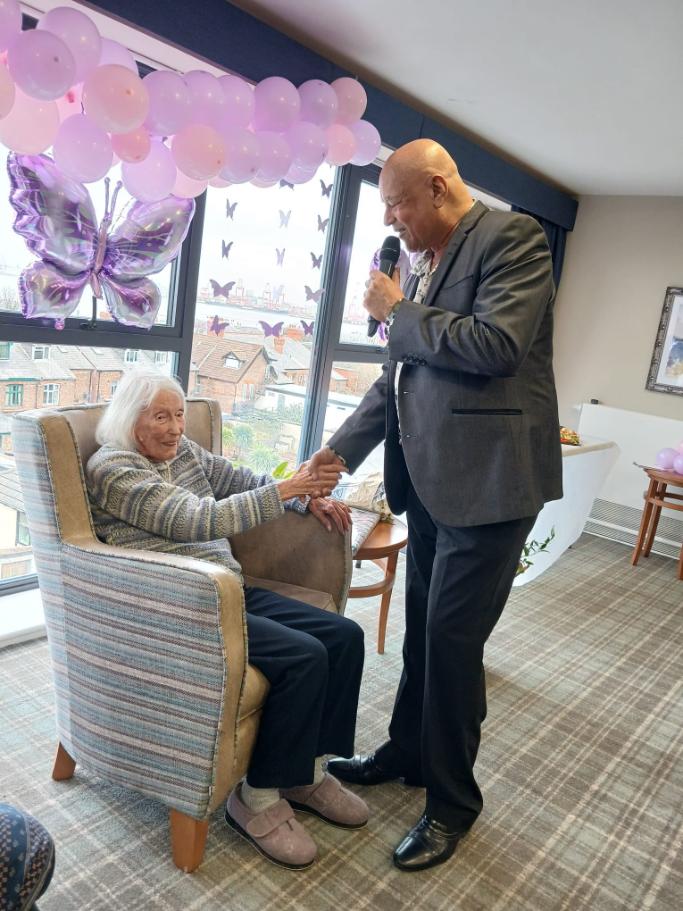 a man singing to an older lady