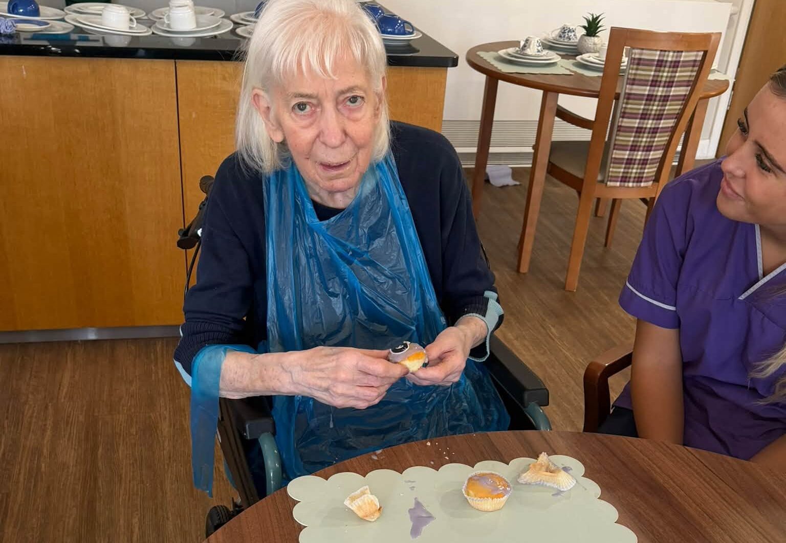 older lady sat with cupcakes